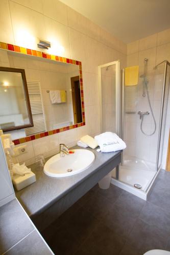a bathroom with a sink and a shower at Hotel Garni Sonnblick in Bad Kleinkirchheim