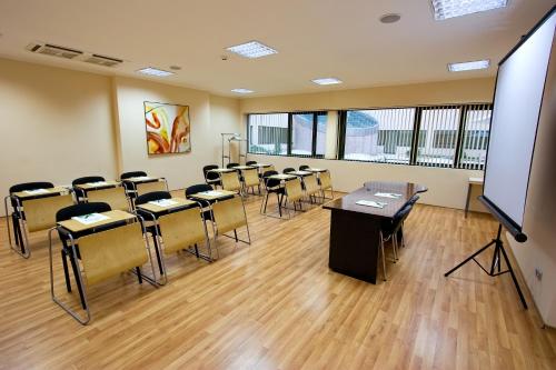 a classroom with desks and chairs in a classroom at Vitosha Park Hotel - Free Indoor Pool & Parking in Sofia
