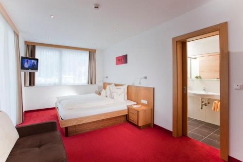 Postel nebo postele na pokoji v ubytování Hotel Garni Auriga