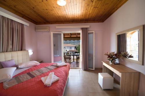 a bedroom with a bed and a view of a patio at Christina Studios in Lygia