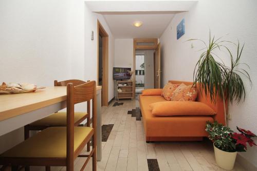 a living room with a couch and a table at House Vera in Baška Voda