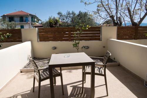 a table and two chairs on a patio at Christina Studios in Lygia