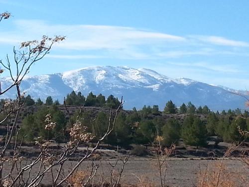 a snow covered mountain in the distance at Cueva Las Yeseras in Baza