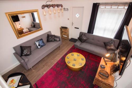 a living room with a couch and a table at Magdalen Quarters in Exeter