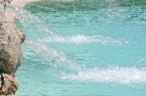 a water fountain spewing water into a swimming pool at Hotel Relais Pian delle Starze in Marina di Camerota