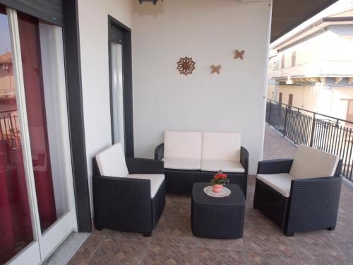 two chairs and a table on a balcony at Bouganville House in Zafferana Etnea