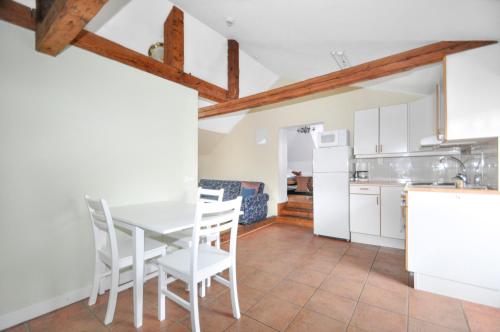 a kitchen and dining room with a table and chairs at Boende Visby in Visby