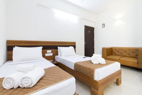 Ένα ή περισσότερα κρεβάτια σε δωμάτιο στο Sanctum Suites Whitefield Bangalore