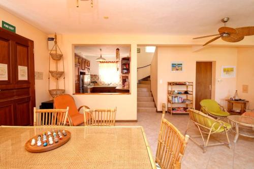 a living room with a table and chairs at Villa Mauridul in Baie du Tombeau