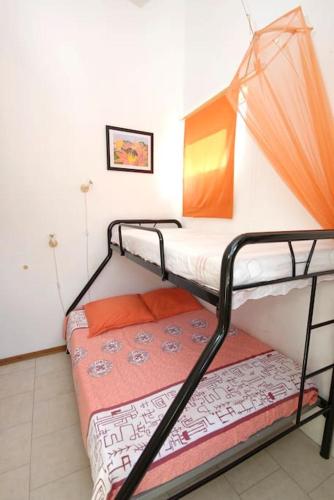 a bedroom with two bunk beds in a room at Villa Mauridul in Baie du Tombeau