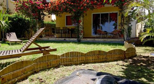 a wooden fence in front of a house at Villa Mauridul in Baie du Tombeau