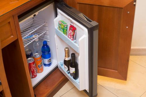 an open refrigerator with food and drinks in it at Adorasuite B&B in Rome