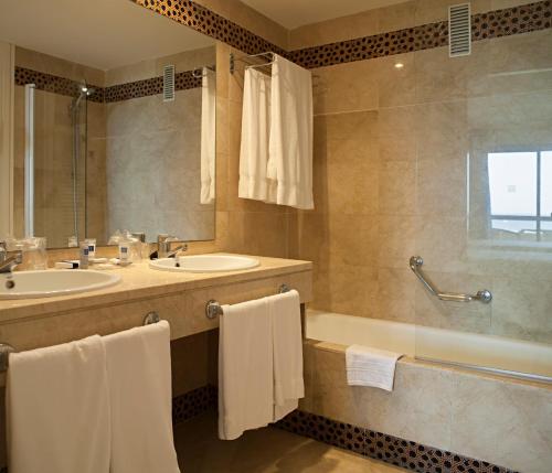 a bathroom with a sink and a tub and a shower at AR Almerimar in Almerimar