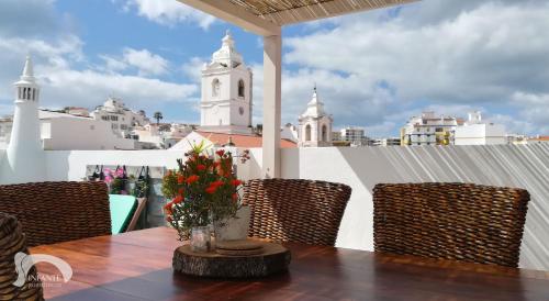 a table and chairs with a view of a city at Infante Guesthouse in Lagos