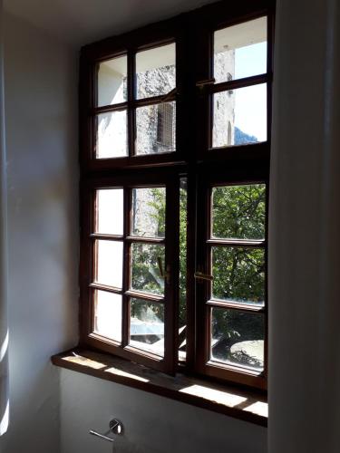 an open window with a view of a tree at Castel Pergine in Pergine Valsugana