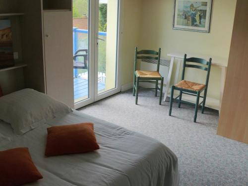 a bedroom with two chairs and a bed and a balcony at Hôtel Le Vivier WISSANT - Vue Mer - Côte d'Opale - Baie de Wissant - 2CAPS in Wissant