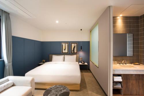 Tempat tidur dalam kamar di Nampo Hound Hotel Premier