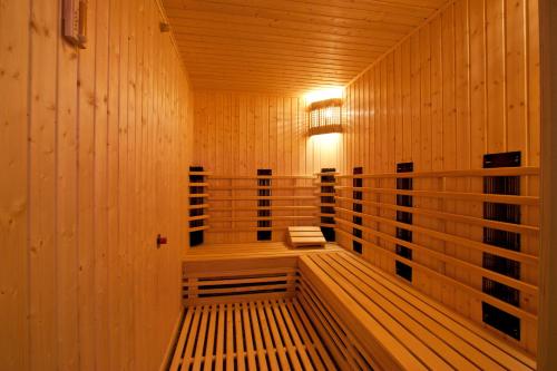 a wooden sauna with a bench in the middle at Vitosha Park Hotel - Free Indoor Pool & Parking in Sofia