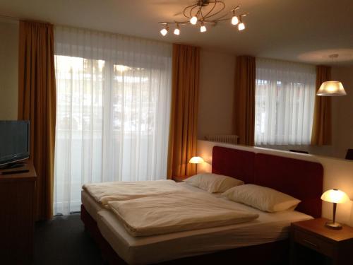 a bedroom with a large bed in front of a window at Restaurant Waldmeisterei in Gera