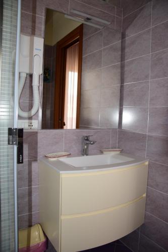 a bathroom with a sink and a mirror at B&B Il Glicine Fiorito in Venice-Lido
