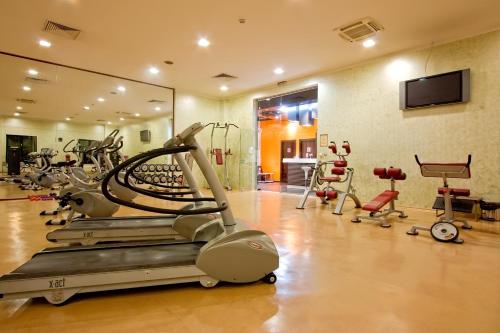 a gym with treadmills and exercise bikes and a mirror at Vitosha Park Hotel - Free Indoor Pool & Parking in Sofia