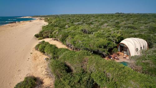 a dome house on the beach next to a beach at Wild Coast Tented Lodge - Relais and Chateaux - All Inclusive in Yala
