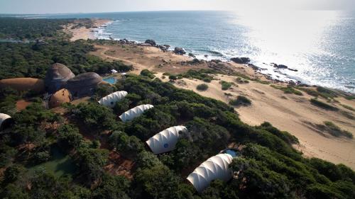 an aerial view of a group of tents on a beach at Wild Coast Tented Lodge - Relais and Chateaux - All Inclusive in Yala