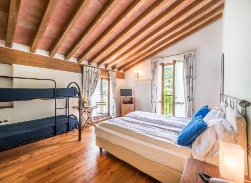 a bedroom with a bed and a wooden ceiling at Agriturismo Cà Del Lago in Gravedona