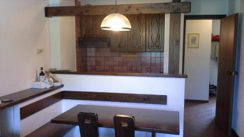 a kitchen with a counter and a table and chairs at Monterotta 18 in Sestriere