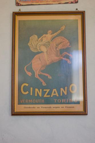 a poster of a woman riding a horse on a wall at Ristorante Buasca in Cuorgnè