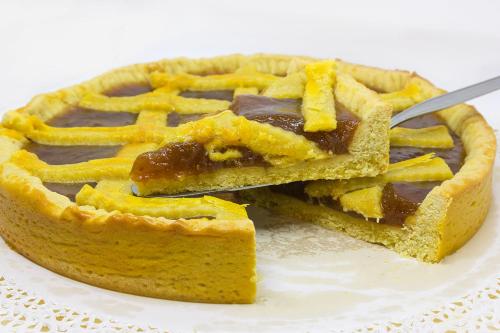 a pie on a plate with a fork in it at Ristorante Buasca in Cuorgnè