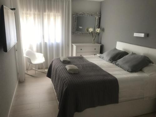 アレニス・デ・マルにあるLuxury Can Montiのベッドルーム1室(ベッド1台、椅子、窓付)