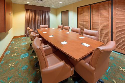 a conference room with a large wooden table and chairs at Wingate by Wyndham Erlanger - Florence - Cincinnati South in Erlanger
