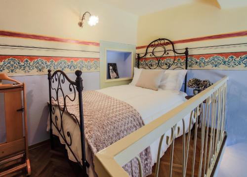 a bedroom with a bed with a wrought iron headboard at L'Anfiteatro Nascosto in Florence