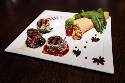 a white plate with different types of food on it at Best Western Plus Paradise Hotel Dilijan in Dilijan