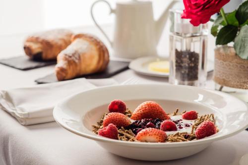 a bowl of cereal with strawberries on a table at Highfield Park in Hook