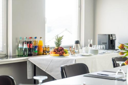 a kitchen with a table with a bowl of fruit on it at GT3 Hotel in Honerath