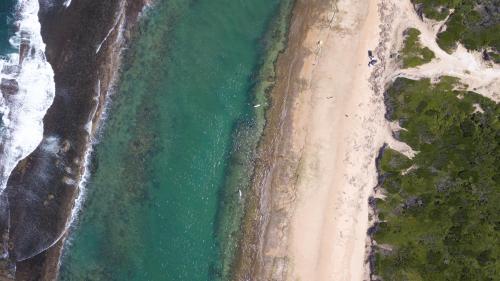 an overhead view of a beach and the ocean at Naara Eco Lodge & Spa in Chidenguele