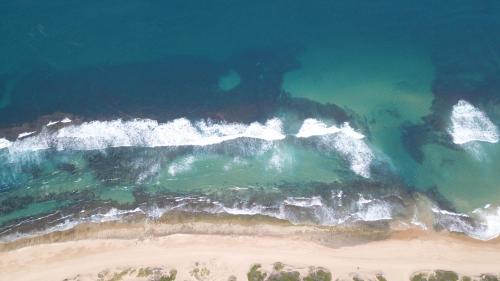 an aerial view of a beach and the ocean at Naara Eco Lodge & Spa in Chidenguele