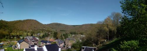 a small town in the mountains with houses and trees at La petite maison in Aywaille