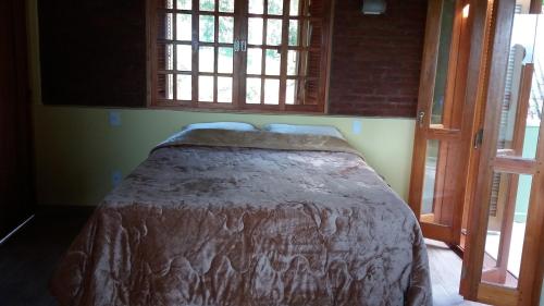 Una cama o camas en una habitación de Pousada Campestre Sítio da Lua