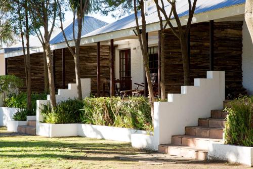 a house with stairs in front of it at Silvermist Wine Estate in Cape Town