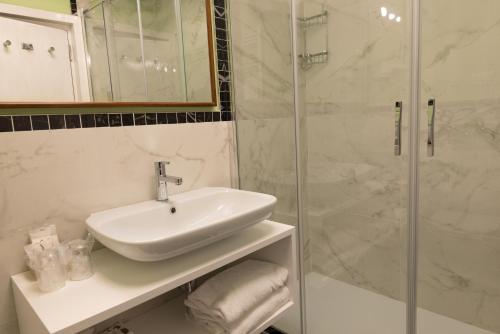 a bathroom with a sink and a shower at Grand Hotel Tamerici & Principe in Montecatini Terme
