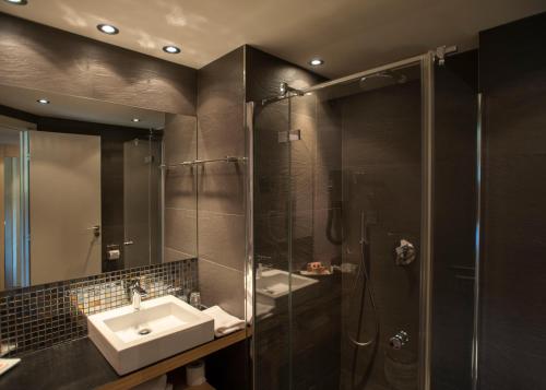 een badkamer met een wastafel en een douche bij Hôtel Castell'Verde in Porto-Vecchio