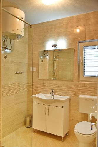 a bathroom with a sink and a toilet at Apartments & Rooms Jelka in Kotor