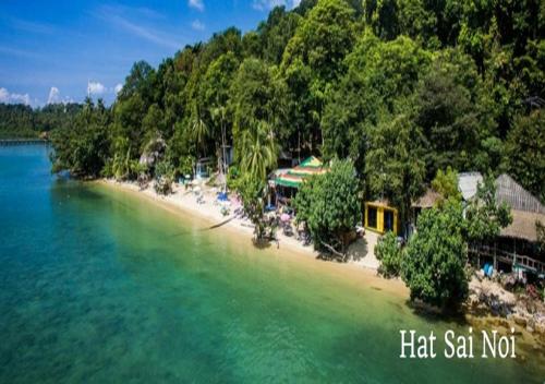 a beach with a group of people on it at Secret Garden Family House in Ko Chang