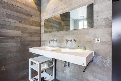 a bathroom with a white sink and a mirror at CMG - Suite Premium Tour Eiffel - 31 in Paris