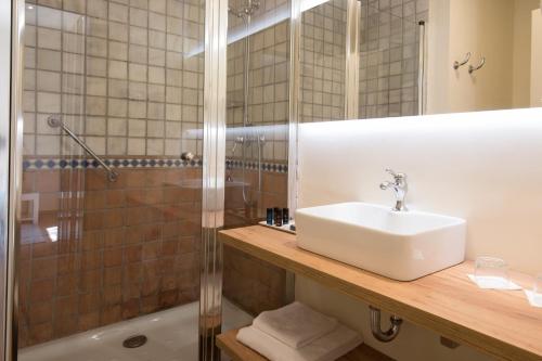 a bathroom with a sink and a shower at Hotel Convent de Begur in Begur