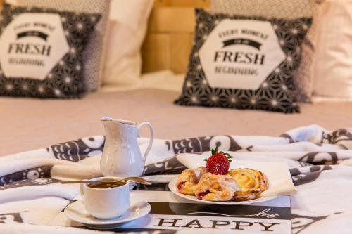 a table with a plate of food and a cup of coffee at Chaty Zakopane in Zakopane