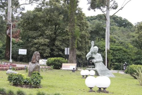 a group of statues in a park with trees at Hostería Atahualpa Yupanqui in Tafí Viejo